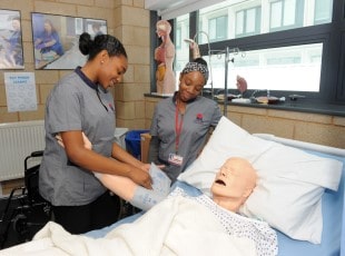 Health & Social Care students working with dummy