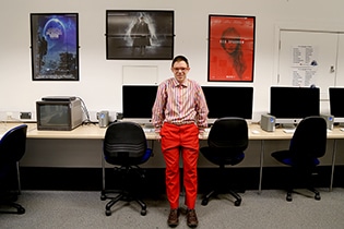 Alex standing by the computers