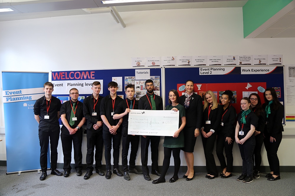 big cosy tea party cheque being held by the students