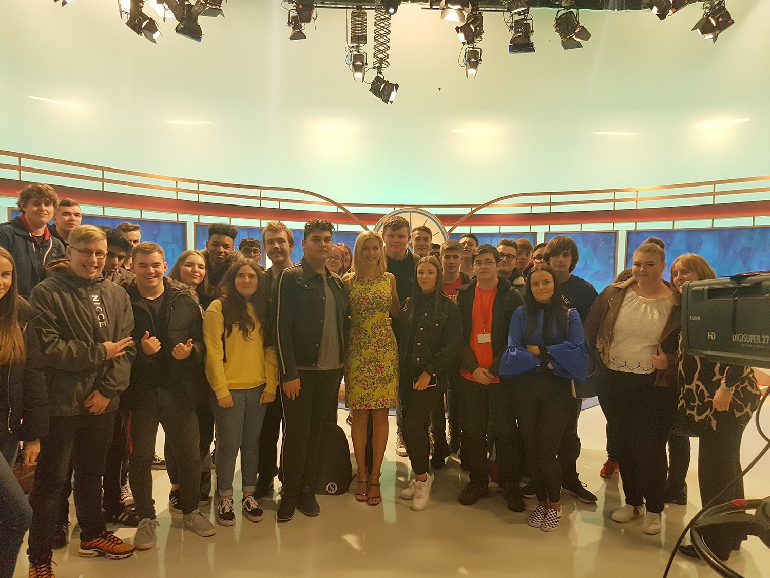 students standing with Rachel Riley