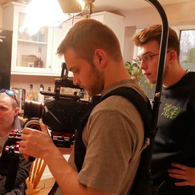 Daniel in the kitchen with a camera man filming