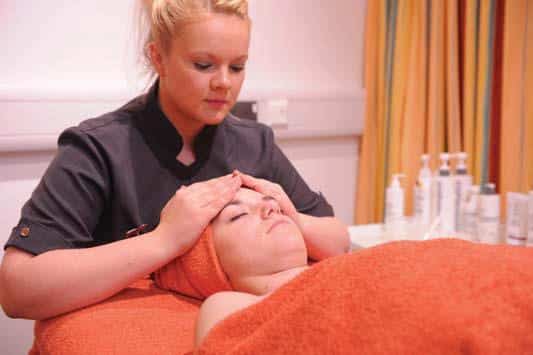 Woman receives head massage.