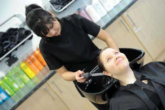 Woman has her hair washed in a salon.