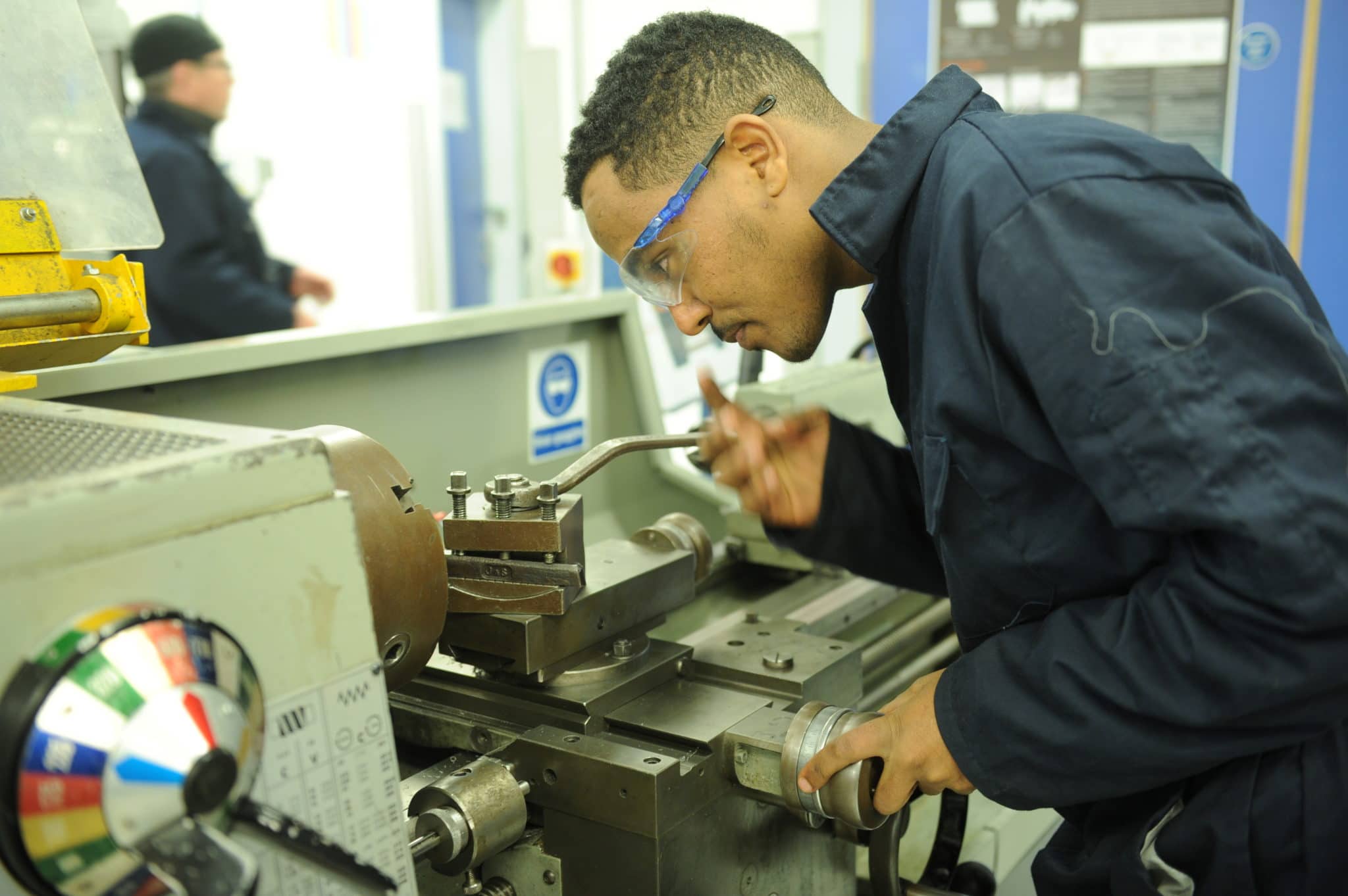 manufacturing engineering student operating machine