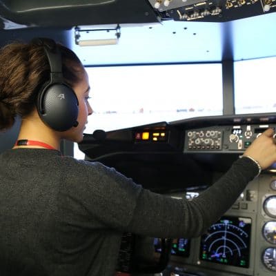 female trainee pilot pressing a button