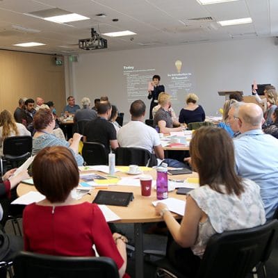 conference event full of people watching a speaker