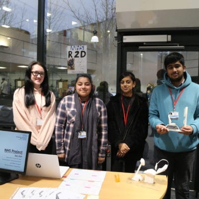 Four college students standing in a line.