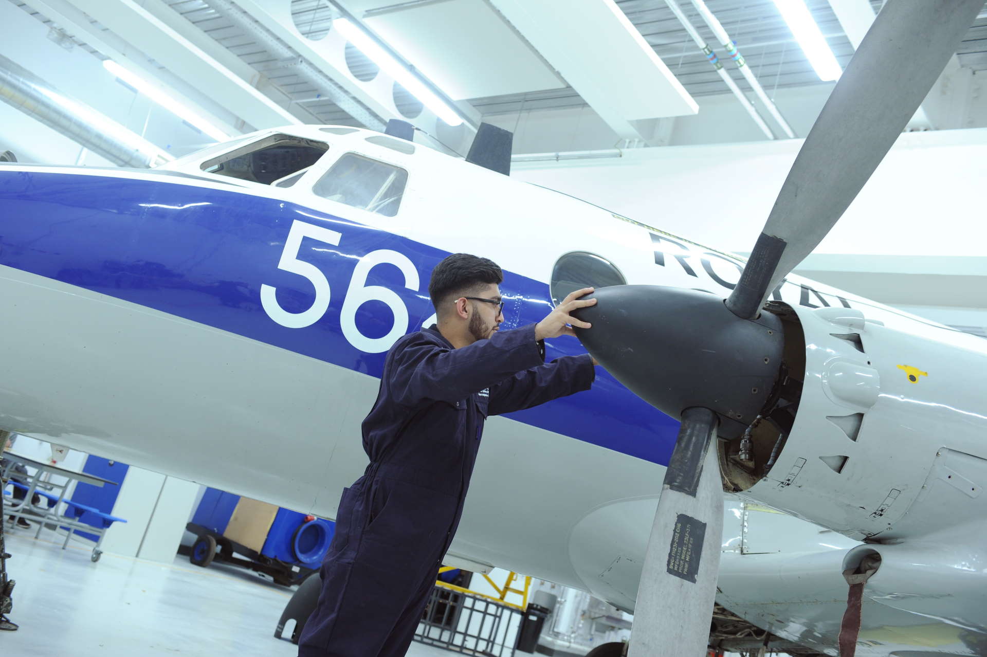 Aerospace Engineering student inspects plane propeller.