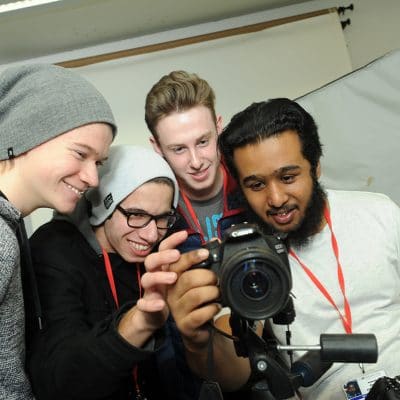 photography students looking at a camera