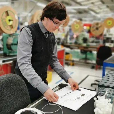 Marcus in the workshop measuring
