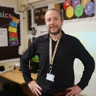 Liam Carr stands in his classroom hands on hips
