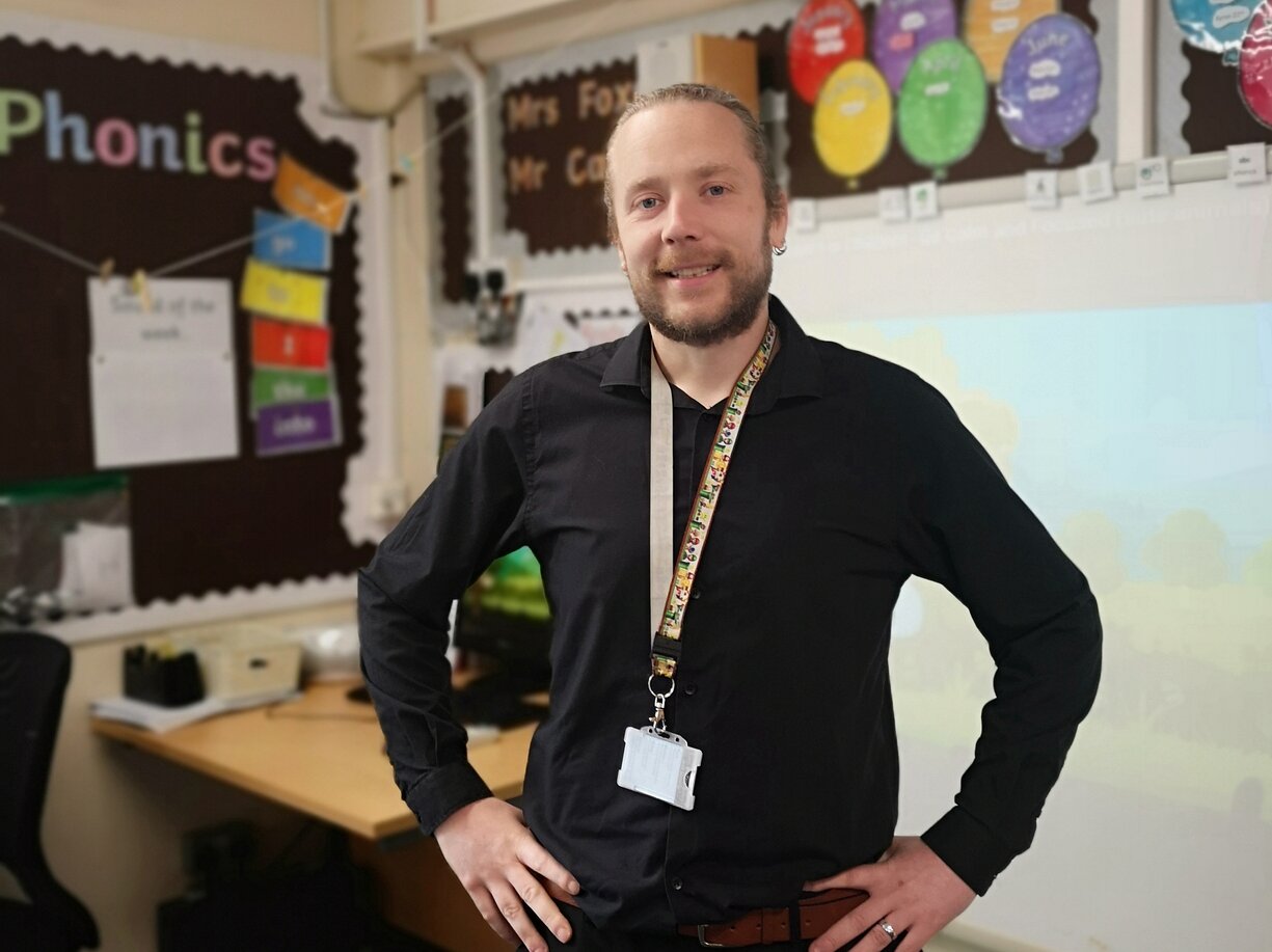 Liam Carr stands in his classroom hands on hips