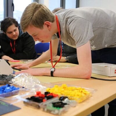 two male students work out problems at a table