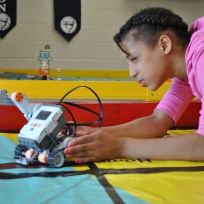 a female student measures on the floor with a machine