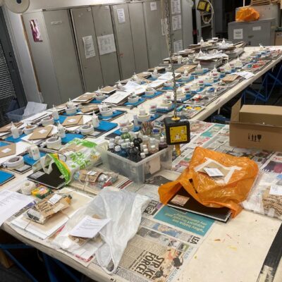 Art supplies laid out on a desk for packs.