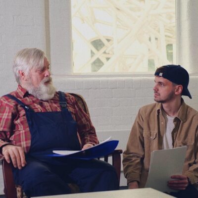 Elliot Roberts sits with the older man cast as Burt in the movie