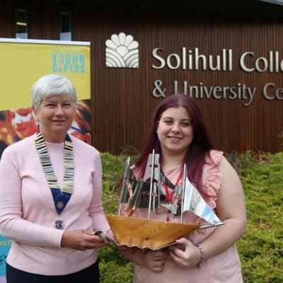 Katie is presented with the award which is a ship design by a member of Shirley Lions Club