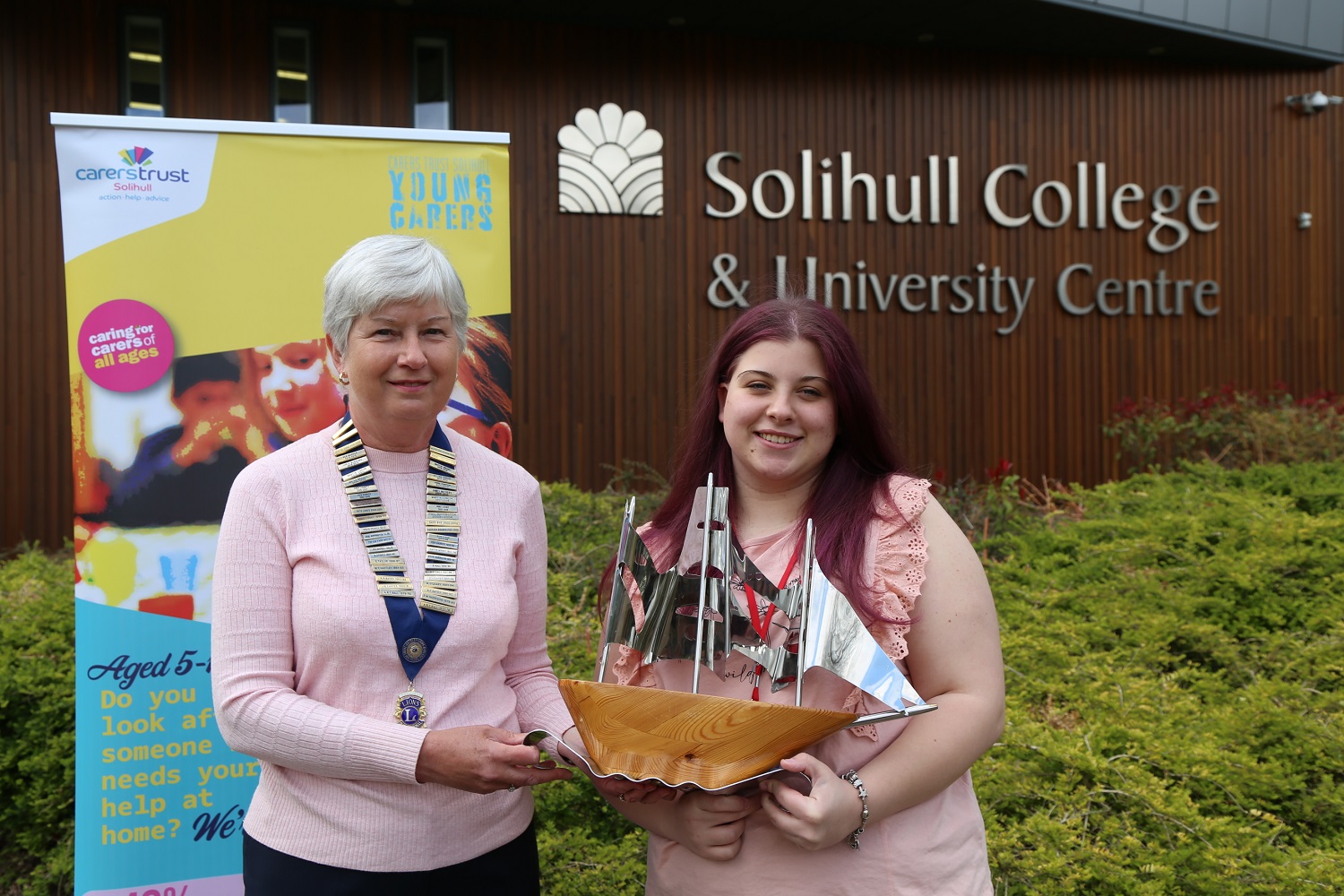 Katie is presented with the award which is a ship design by a member of Shirley Lions Club