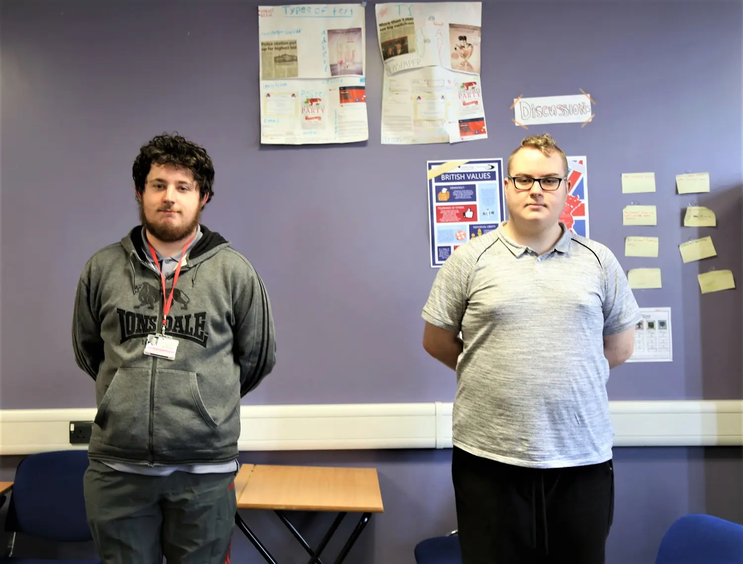 Students Rafe and James stand in their classroom