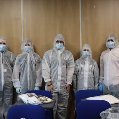 students stood in a row in their boiler suits in a classroom