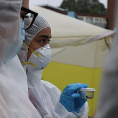 a female student in a boiler suit holds evidence