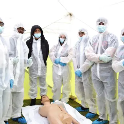 Students stood in boiler suits in the crime scene tent