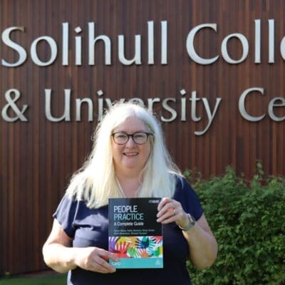 Nicky poses with the book outside the College entrance.