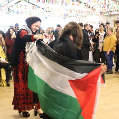 Students dancing with flags