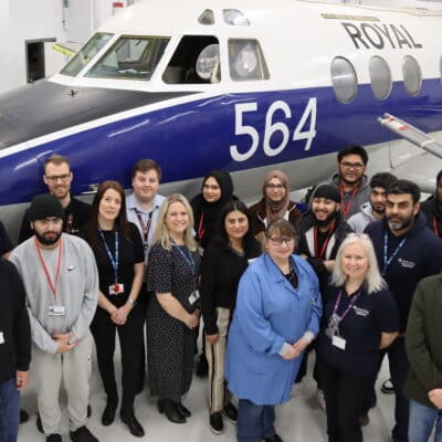 people standing in front of aircraft looking up