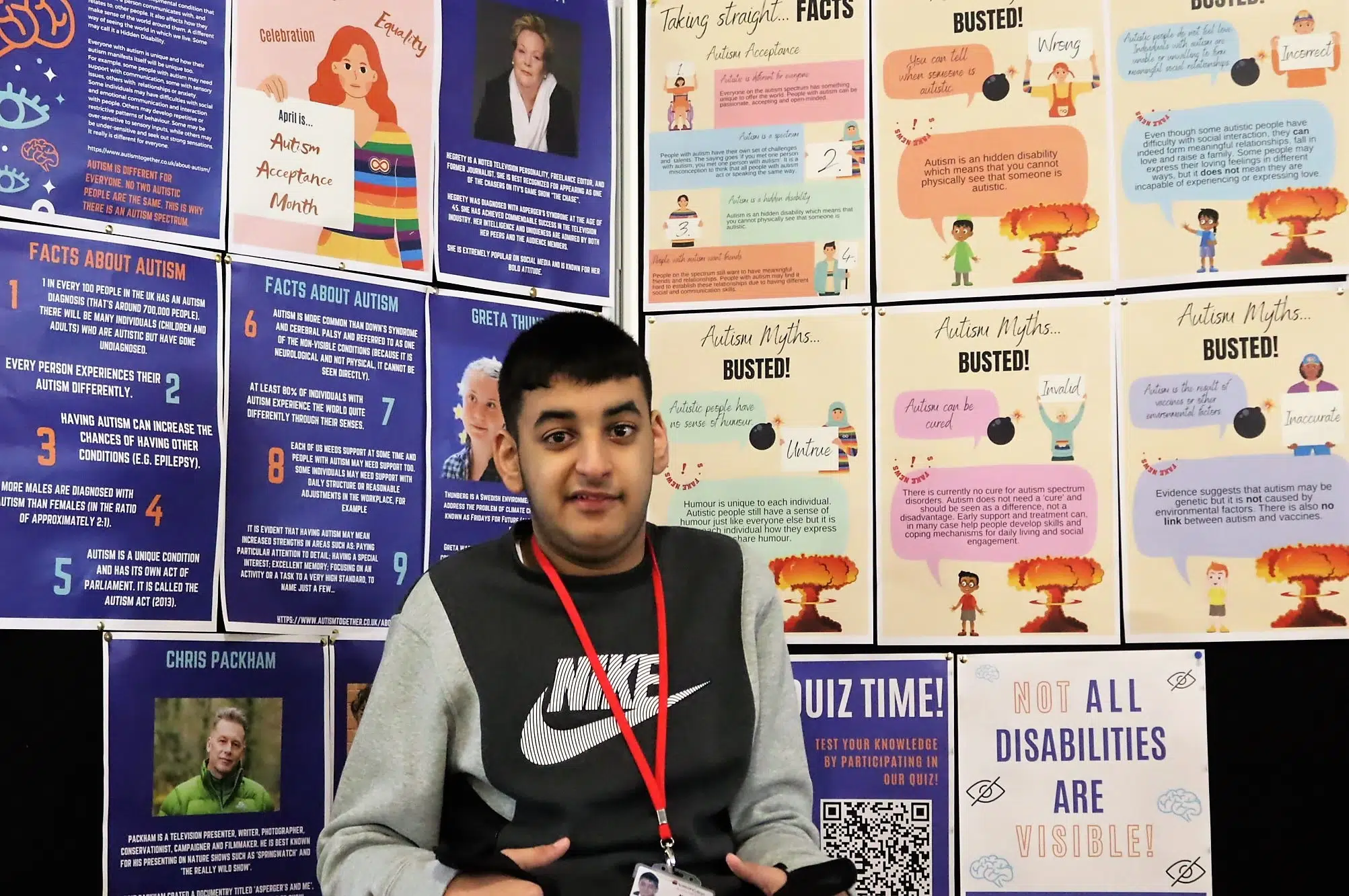 Student standing in front of notice board
