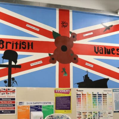 Union Flag Mural on wall with student standing in front
