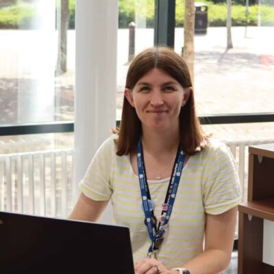 Kerry at a desk with her laptop