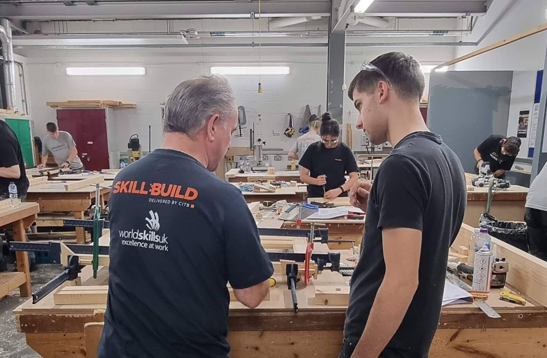 Harry talking to judge at skillbuild