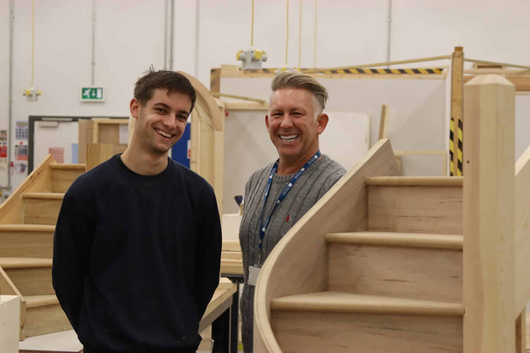 Harry standing beside lecturer arron ward smiling