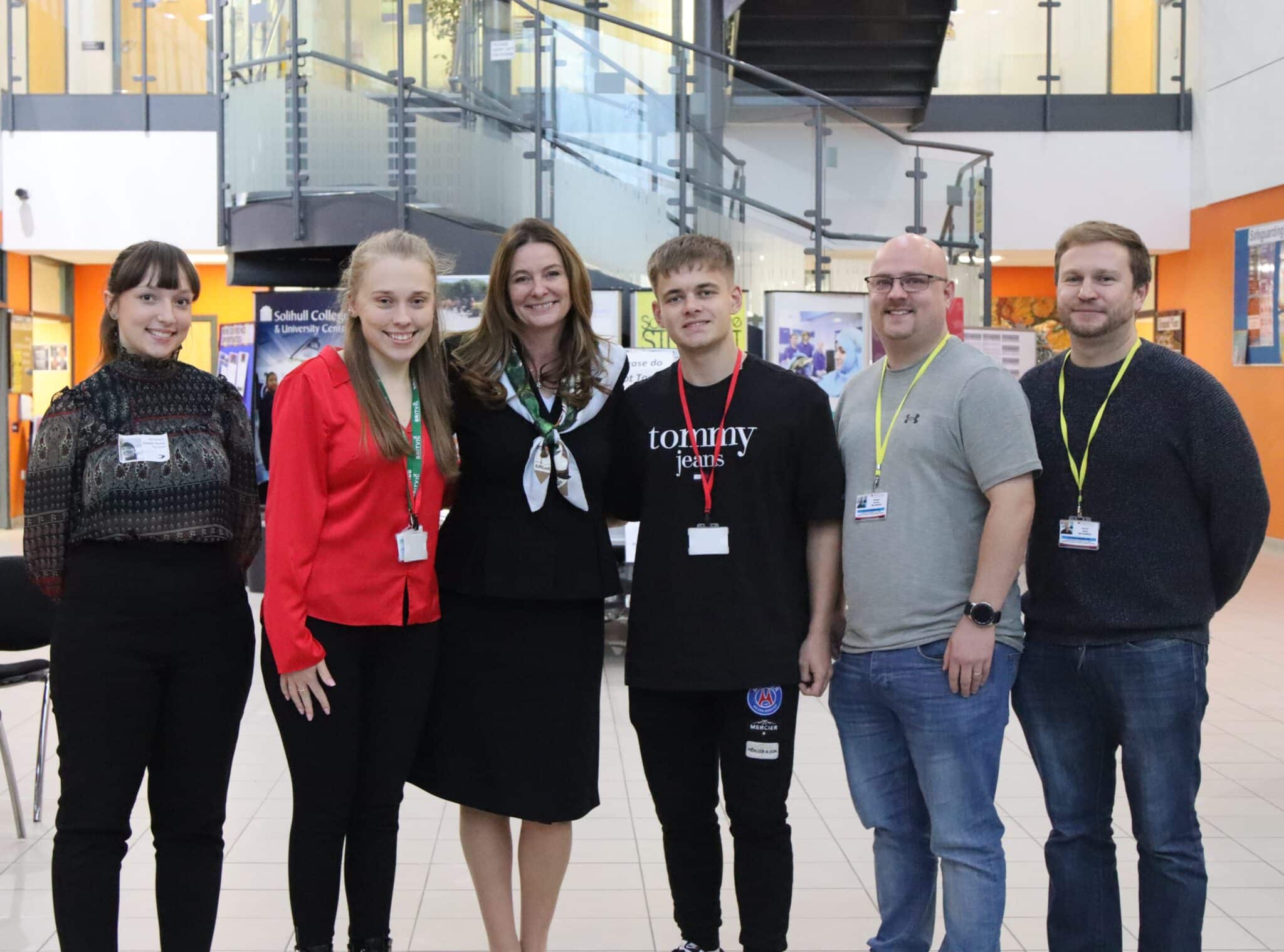 students and Gillian Keegan standing in atrium at woodlands