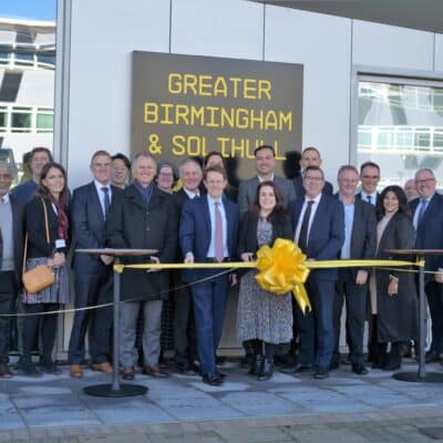 Group of people standing in front of yellow ribbon
