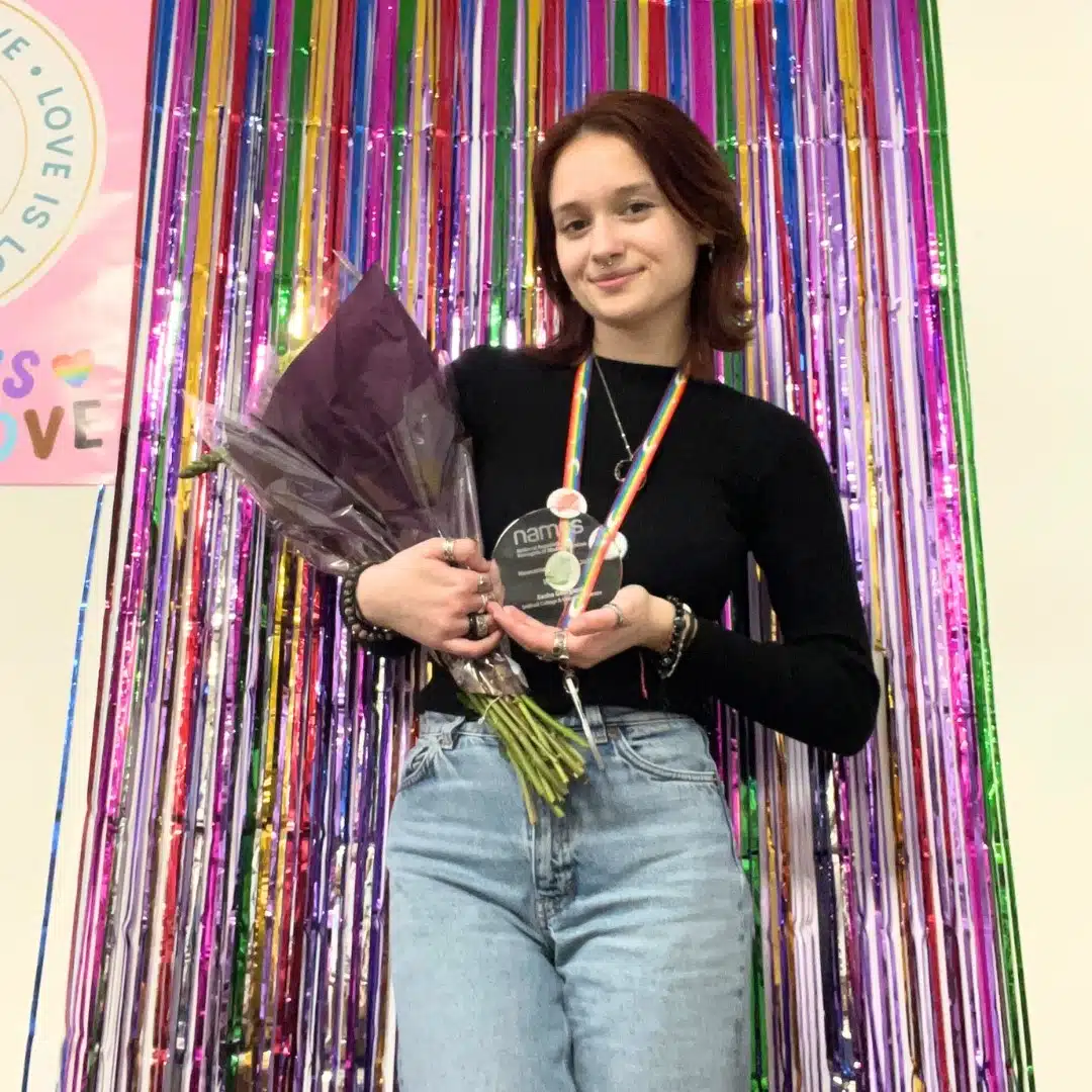 student holding award