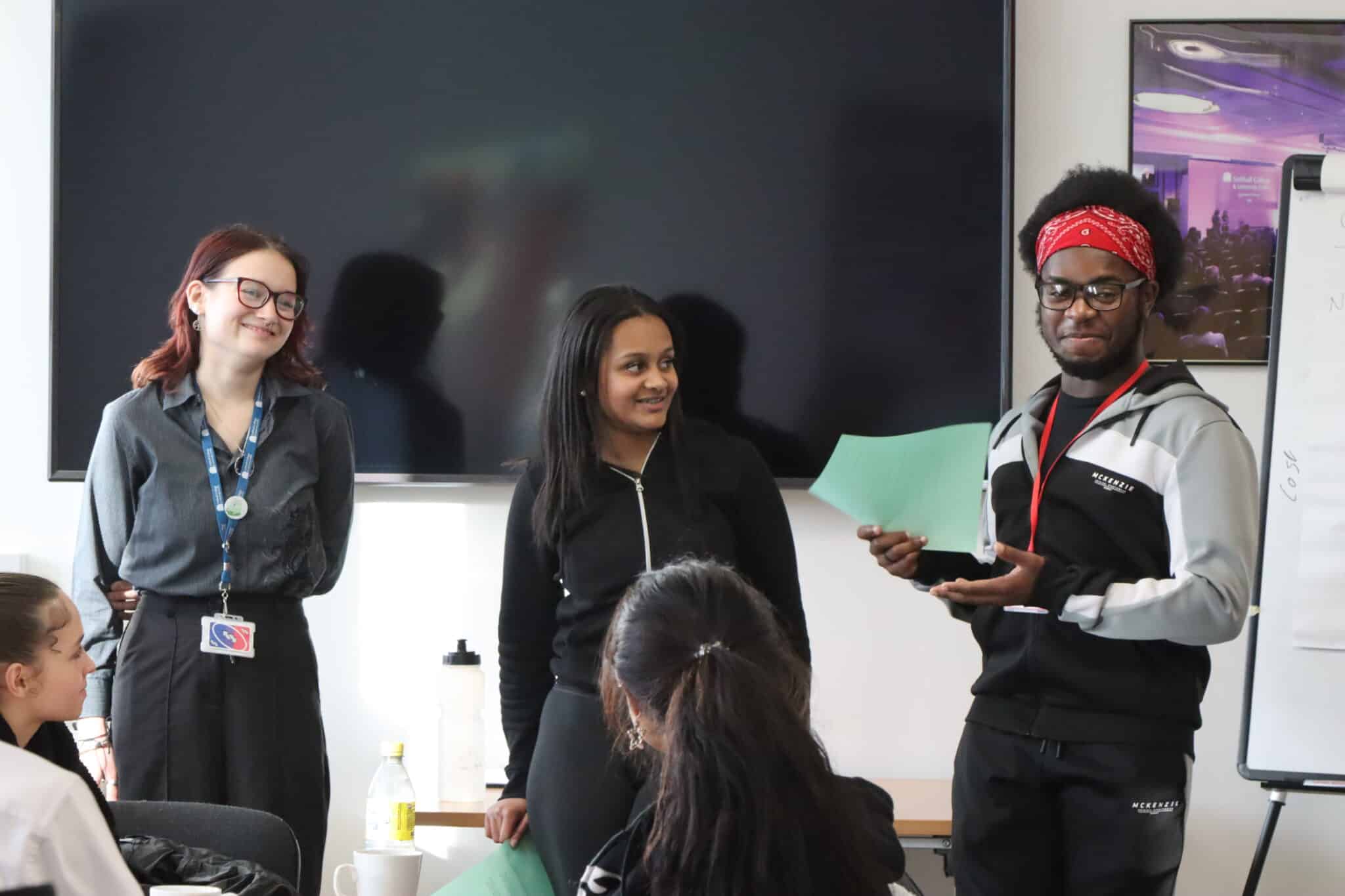 three students delivering a talk