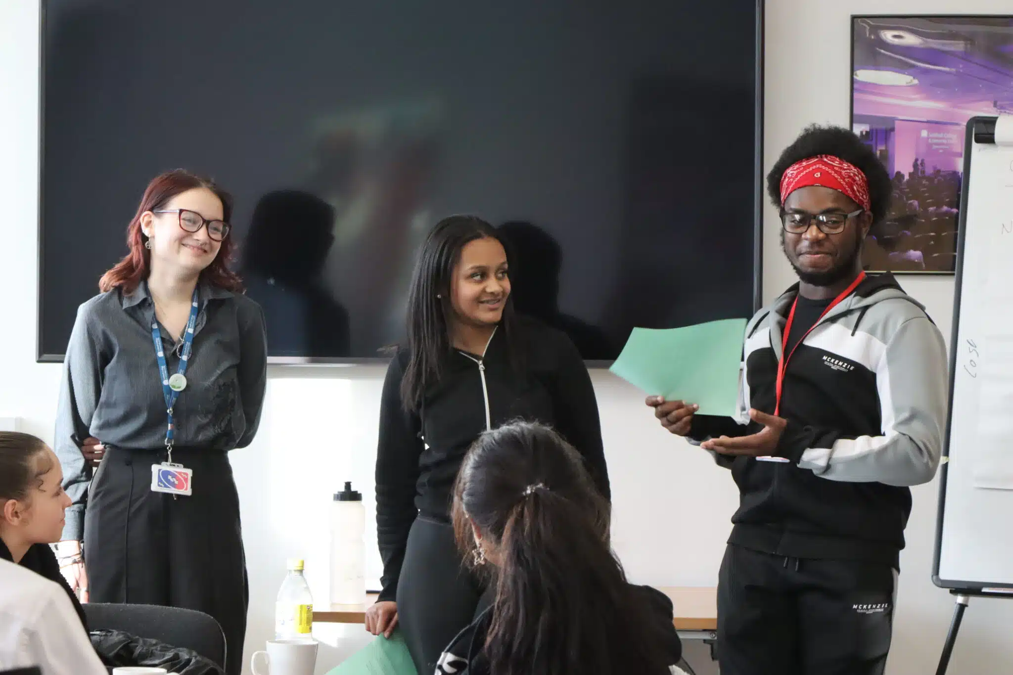 three students delivering a talk