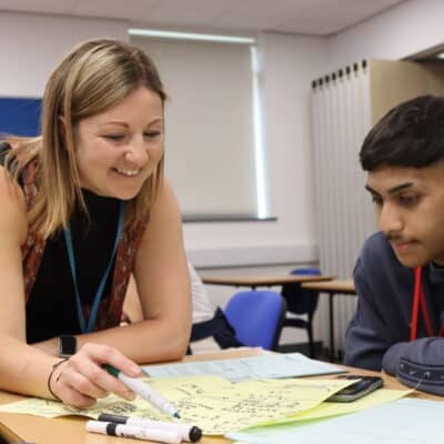 Maths teacher Holly working with a student in the classroom