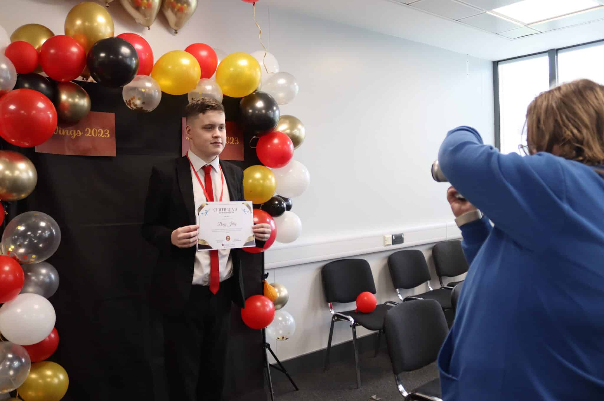 male student with his certificate