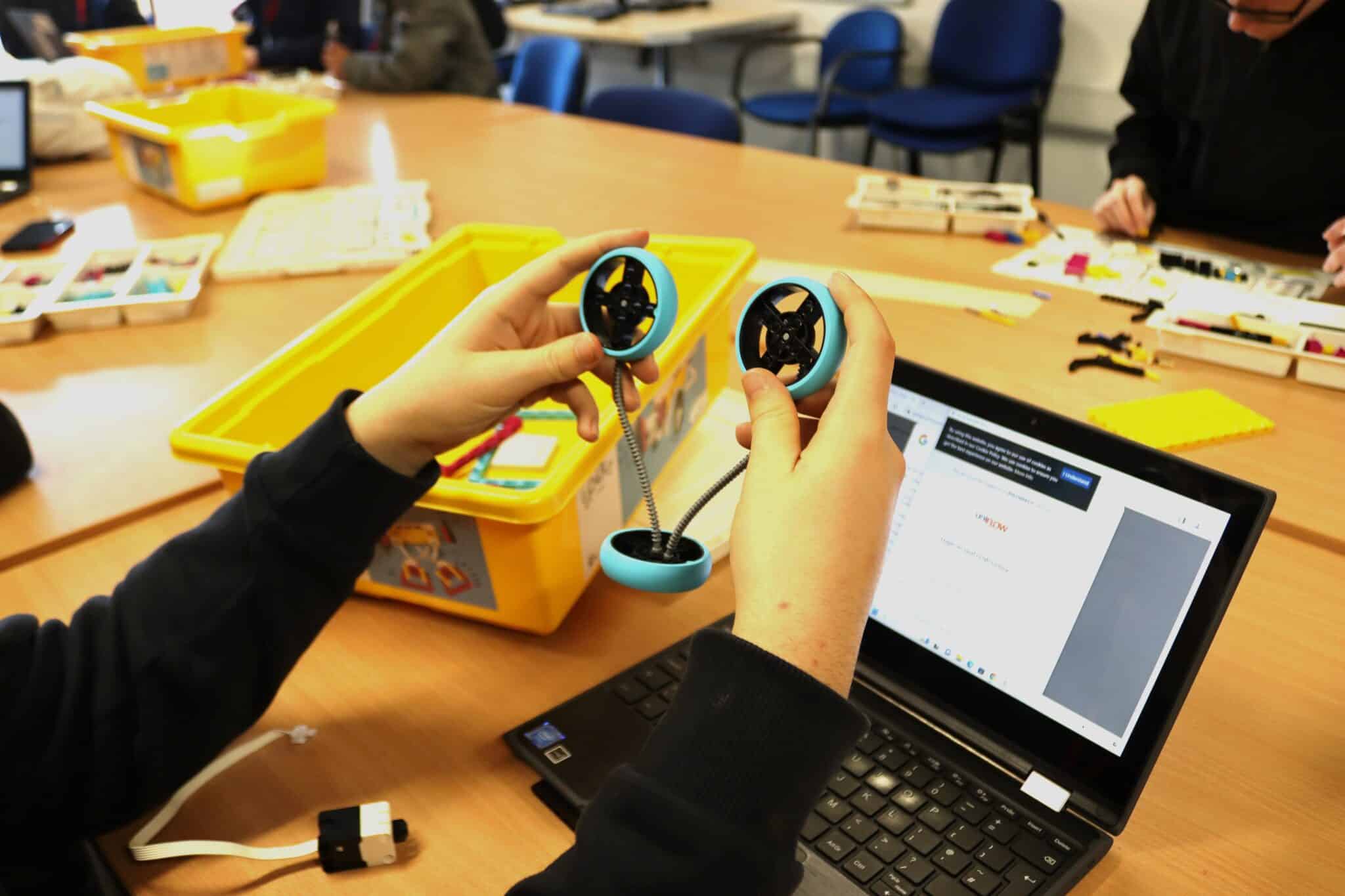 student with piece of lego equipment