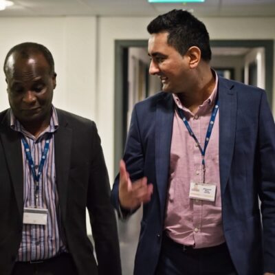 College staff talking in corridor