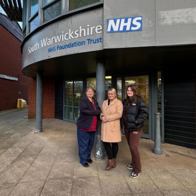 NHS workers who are studying maths and english standing outside hospital