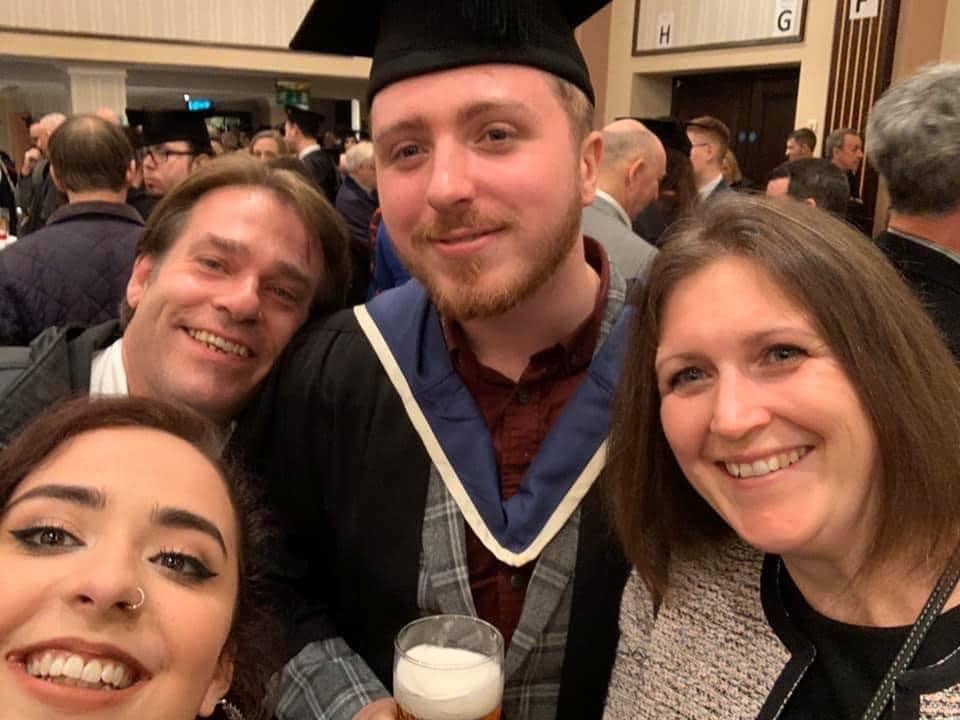 Marc at graduation with friends and family