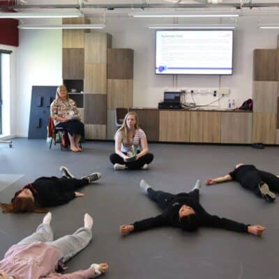 students lying on floor during mental health workshop