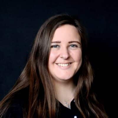 sarah breslin in black smiling at camera