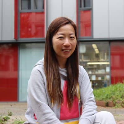 Mum thrives thanks to College's adult courses - Kitty sat on the steps in front of college building
