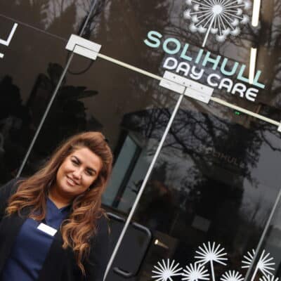 Jess Dolan standing in front of day care entrance