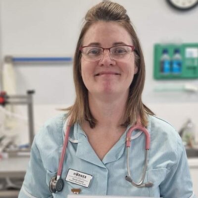 Sarah smiling at camera at vets